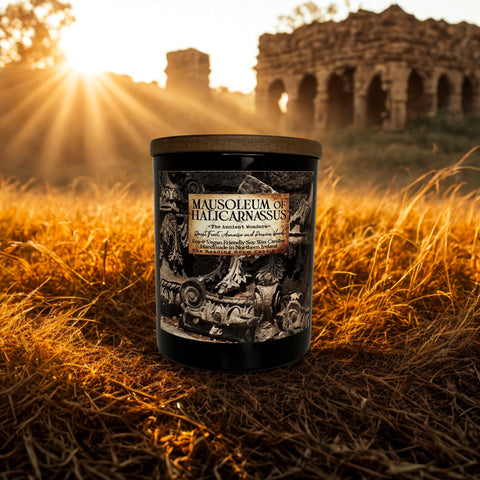 Candle labeled 'Mausoleum of Halicarnassus' in a field with ruins in the background