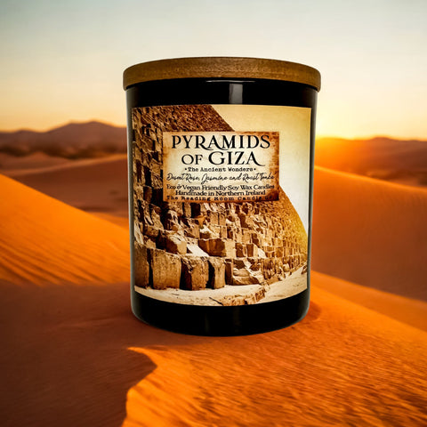 Candle labeled 'Pyramids of Giza' in a desert setting with sand dunes and sunset.