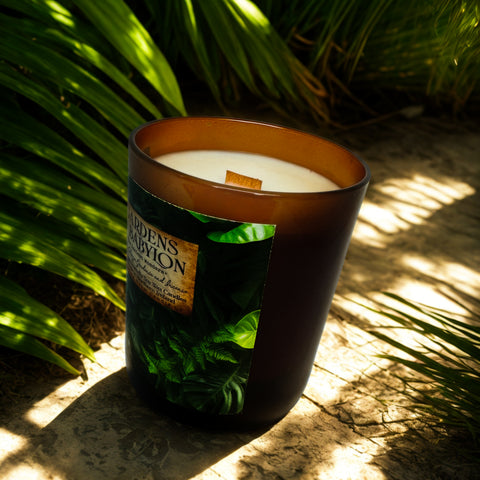 Candle with a green label in front of green foliage