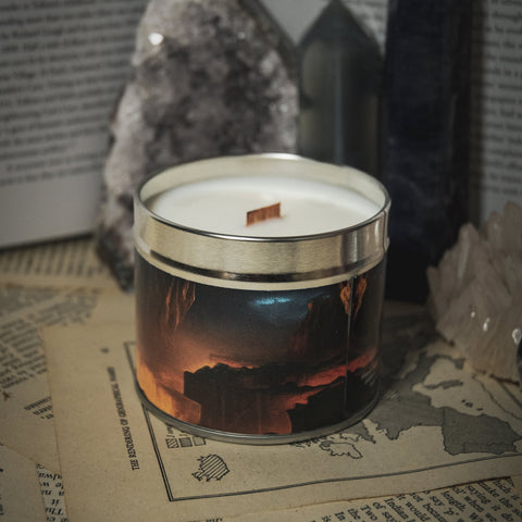 Soy Wax Candle labeled 'Dwarf Mines' on a surface with rocks and books in the background