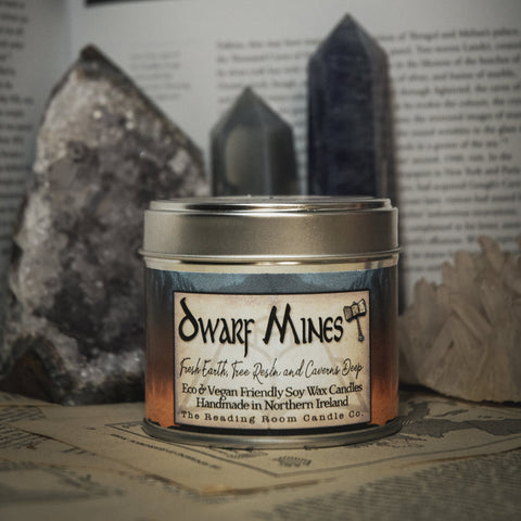 Soy Wax Candle labeled 'Dwarf Mines' on a surface with rocks and books in the background