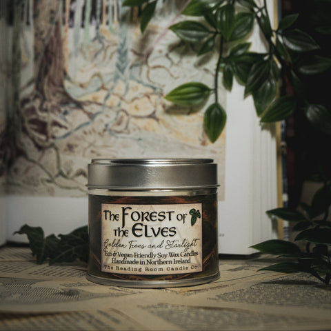 Soy Wax Candle tin labeled 'The Forest of the Elves' on a surface with a blurred natural background