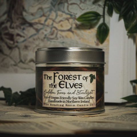 Soy Wax Candle tin labeled 'The Forest of the Elves' on a surface with a blurred natural background