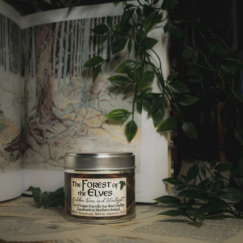 oy Wax Candle tin labeled 'The Forest of the Elves' on a surface with a blurred natural background