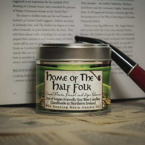 Soy Wax Candle labeled 'Home of the Half Folk' on a table with an open book 