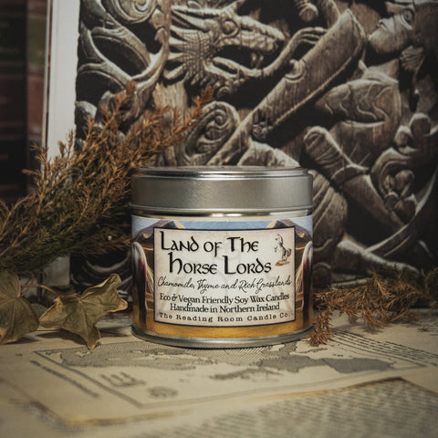 Soy Wax Candle labeled 'Land of the Horse Lords' in front of a norse sculpture