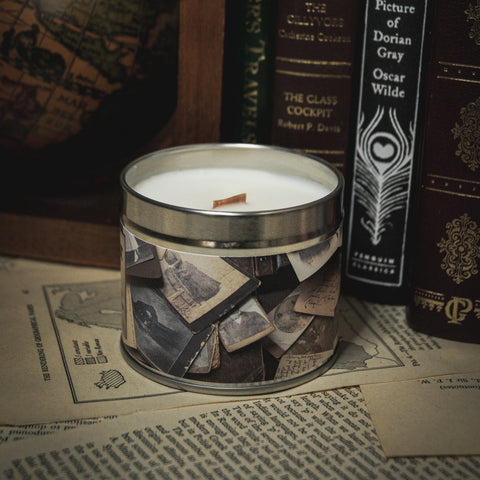 Soy Wax Candle labeled 'The Archivist' on a surface with books in the background