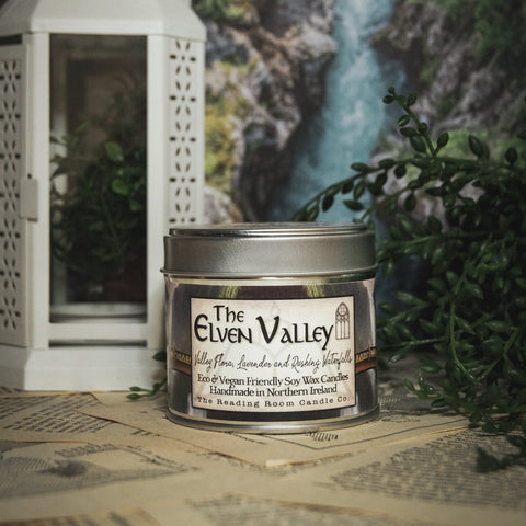 Soy Wax Elven Valley candle in a tin with a decorative background