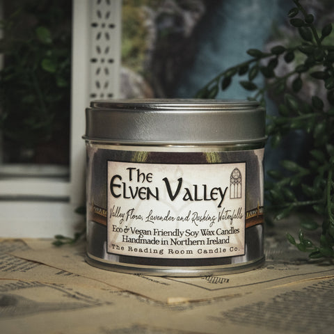 Soy Wax Elven Valley candle in a tin with a decorative background