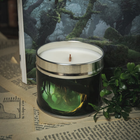 Soy Wax Candle labeled 'Realm of the Whispering Trees' on a surface with a forest-themed background.