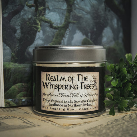 Soy Wax Candle labeled 'Realm of the Whispering Trees' on a surface with a forest-themed background.