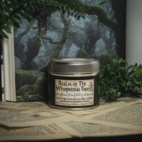 Soy Wax Candle labeled 'Realm of the Whispering Trees' on a surface with a forest-themed background.