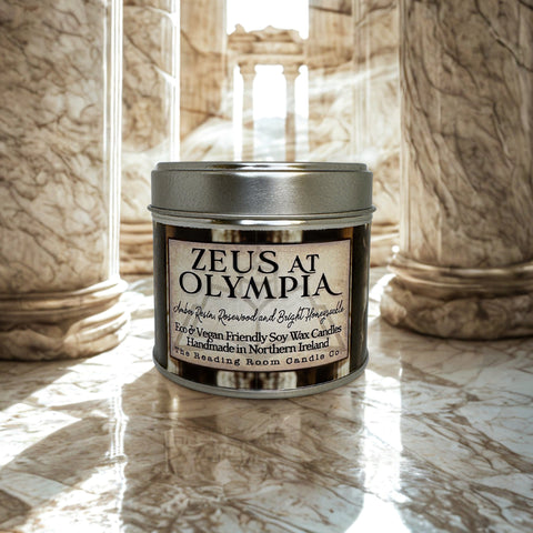 Candle labeled 'Zeus at Olympia' on a marble surface with classical columns in the background